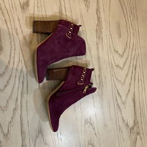 Burgundy booties with gold accents.